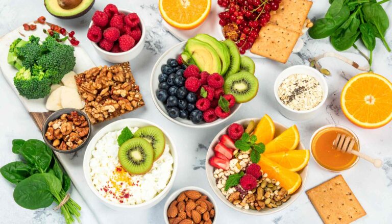 A vibrant display of the Best Gut Health Foods for 2025, including yogurt, berries, leafy greens, and grains, styled for HealthReflected.com’s gut wellness blog post.