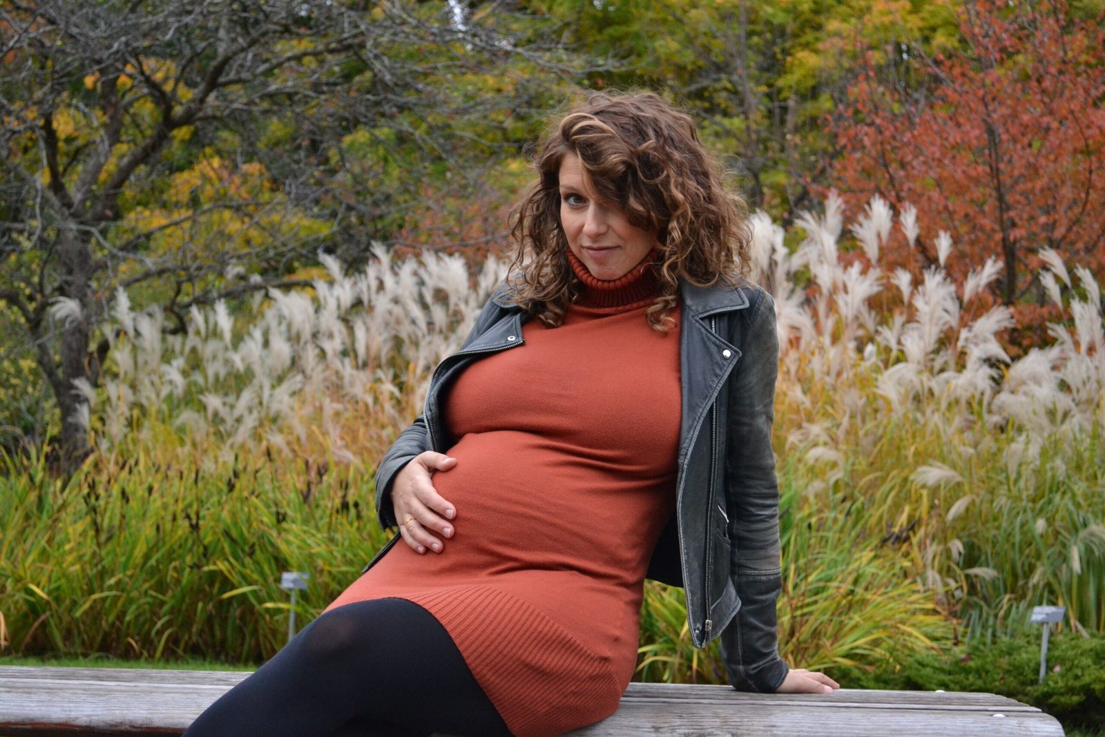 Pregnant woman gently holding her belly